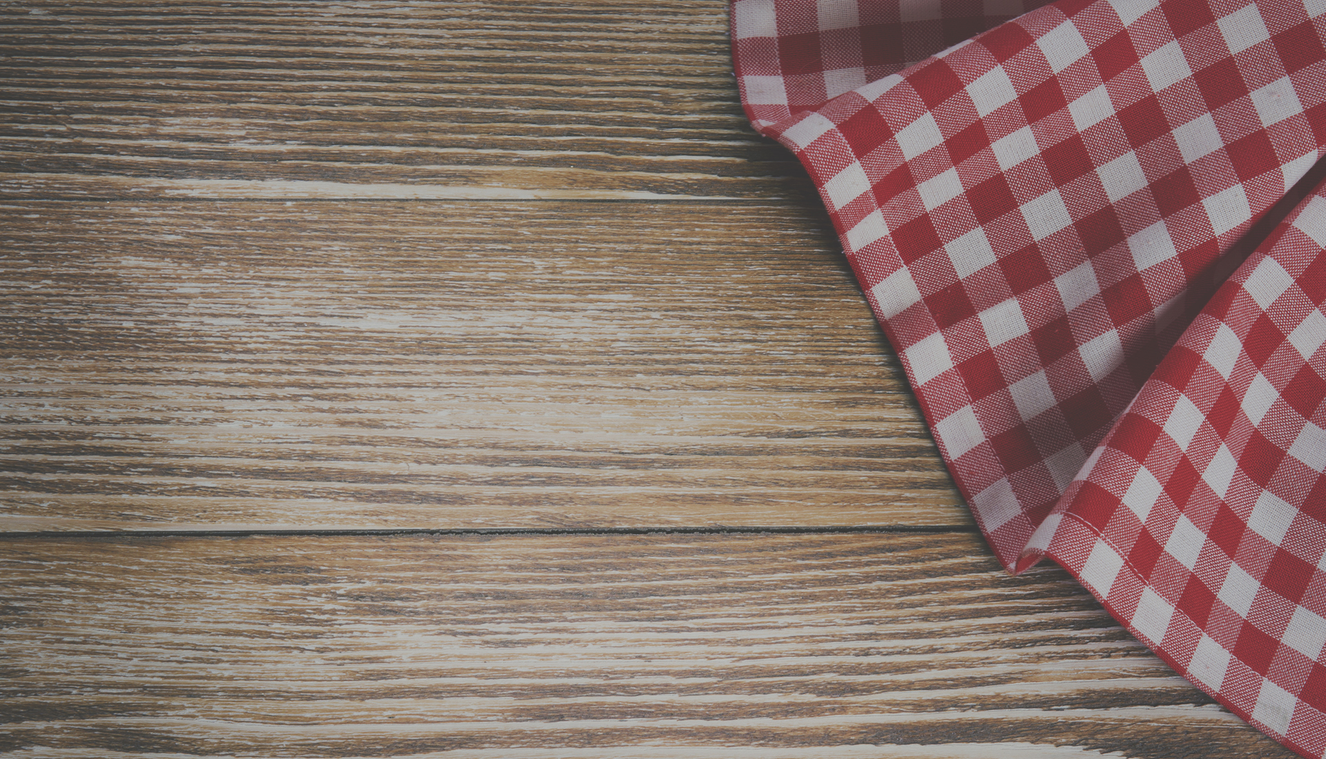 Red picnic cloth on a wooden table